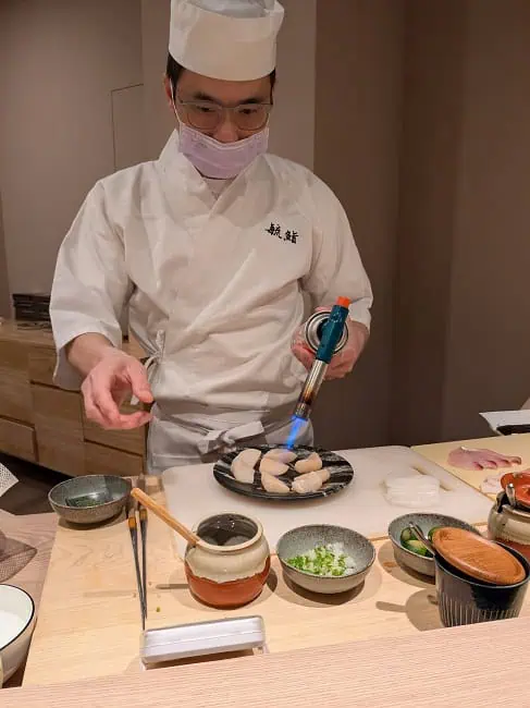 The chef preparing sushi in front of us
