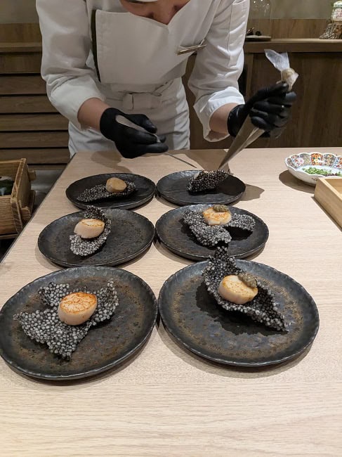 Hokkaido scallops with crab roes on top of squid-ink wafers